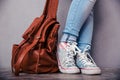 Female legs with leather backpack Royalty Free Stock Photo