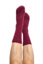 Female legs in purple hand knitted wool socks