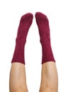 Female legs in purple hand knitted wool socks