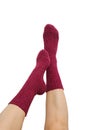 Female legs in purple hand knitted wool socks