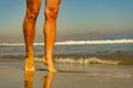 Female legs on sand beach