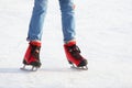 Female legs in skates on an ice rink Royalty Free Stock Photo