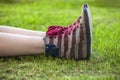 Female legs in sneakers with the design of the American flag on Royalty Free Stock Photo