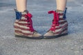 Female legs in sneakers with the design of the American flag on Royalty Free Stock Photo