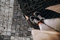 Female legs in sneakers on paving stones. Teenage feet top view. Prague street Royalty Free Stock Photo