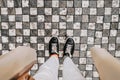 Female legs in sneakers on paving stones. Woman feet top view. Prague street Royalty Free Stock Photo