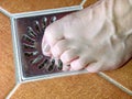 Female legs on stainless cover of shower sink