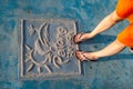 Female legs standing on the plate with the Patong Beach name