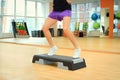 Female legs on the step board during exercise Royalty Free Stock Photo