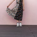 Female legs with stylish sneakers. A stylish vintage dress.