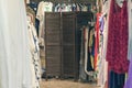 Female legs under wooden folding screen in the store with clothes