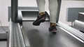 Female legs walking and running on treadmill in gym. Young woman exercising during cardio workout. Feet of girls in Royalty Free Stock Photo