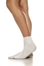 Female legs in white short socks