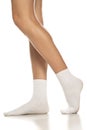 Female legs in white short socks
