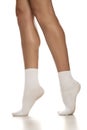 Female legs in white short socks
