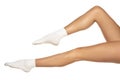 Female legs in white short socks on white