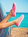 Female legs from the window of car Royalty Free Stock Photo