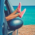 Female legs from the window of car Royalty Free Stock Photo