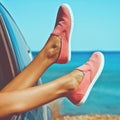 Female legs from the window of car Royalty Free Stock Photo