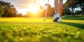 female legs of woman golfer with golf club on lawn on golf course in summer at sunny day close-up Royalty Free Stock Photo