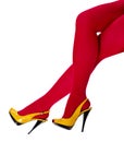 Female legs in yellow shoes and red tights