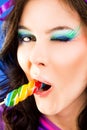 Female licking lollipop blink Royalty Free Stock Photo