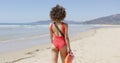 Female lifeguard goes along beach
