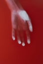 Female lifeless hand in red water, cover for art in horror genre, detective novel, concept defeat