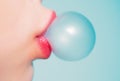 Female lips blowing bubble gum. Close up of a woman face with pink lips and gum bubble. Royalty Free Stock Photo