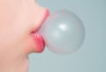 Female lips blowing pink bubble gum. Closeup of a woman face with pink lips and gum bubble. emale lips holding shiny Royalty Free Stock Photo