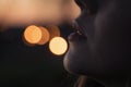 Female lips close-up against a background of city lights