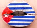 Female lips close up with a picture flag of Cuba. white, red, blue