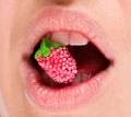 Female lips with raspberry in studio