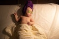 Female little baby infant baby child lying on bed cucumber eyes Royalty Free Stock Photo