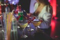 Female lonely girl glam blond woman using smartphone with dating app site is drinking in a bar on a counter with different