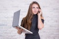 Female long-haired administrator with notebook and telephone