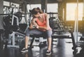 Female looking her arm and sitting with relax after the training session in gym,Concept healthy and lifestyle Royalty Free Stock Photo