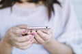 Female looking at her smart phone in hand surfing on internet