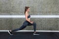 female lunging to the right and stretching glutes Royalty Free Stock Photo