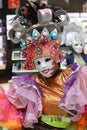 Female in a luxurious costume wearing colorful clothes and a decorative mask