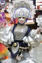 Female in a luxurious costume wearing colorful clothes and a decorative mask