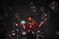 Female magician makes with soap bubbles show, an illusionist