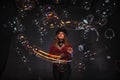 Female magician makes with soap bubbles show, an illusionist