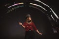 Female magician makes with soap bubbles show