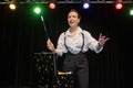 Female magician performing show on stage