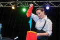 Female magician pulling length material from bag