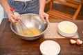 A female makes cupcake in the kitchen, whisking her softened butter in the mixing bowl Royalty Free Stock Photo