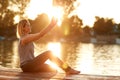 Female making selfie by the river at sunset Royalty Free Stock Photo