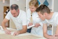 Female and male apprentices with teacher Royalty Free Stock Photo