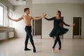 Female and male ballet dancers dancing at barre Royalty Free Stock Photo